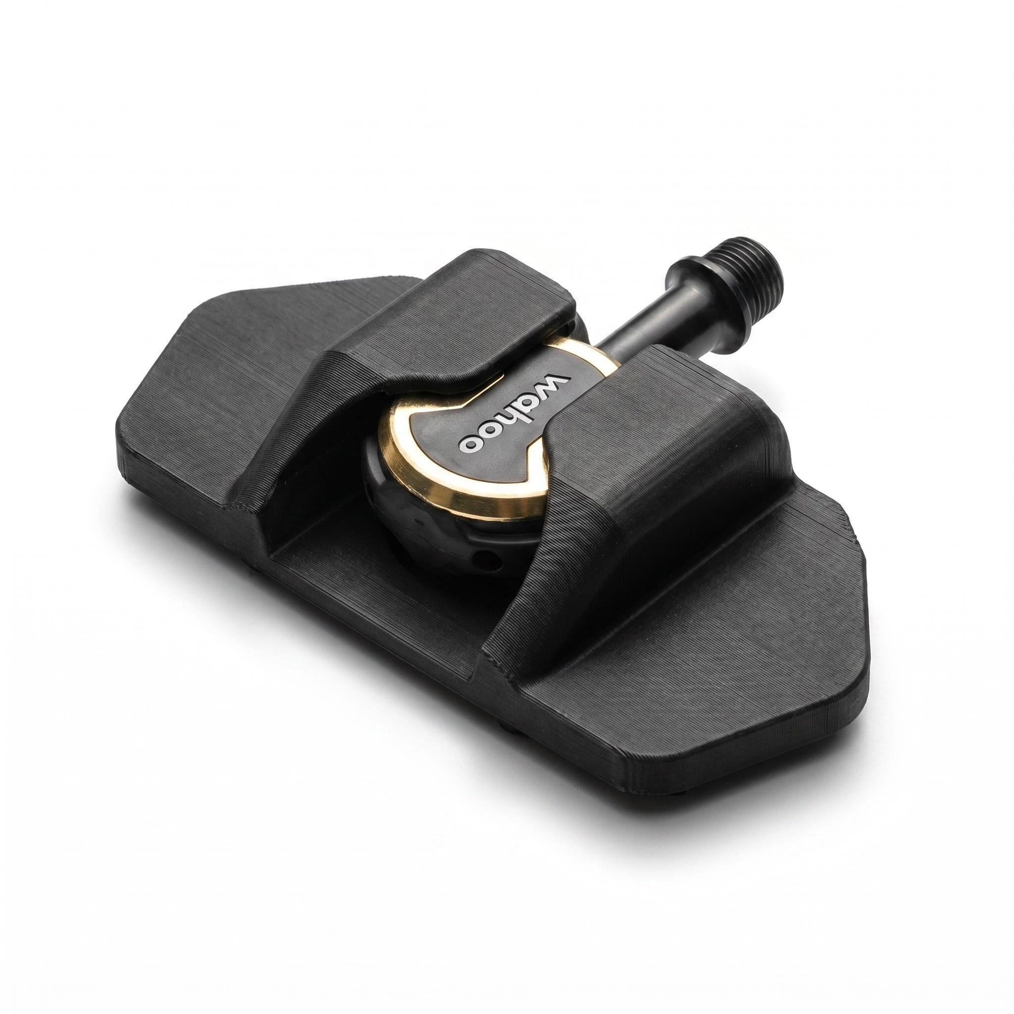 Raised edge blocks and textured centre on a black flat pedal adapter